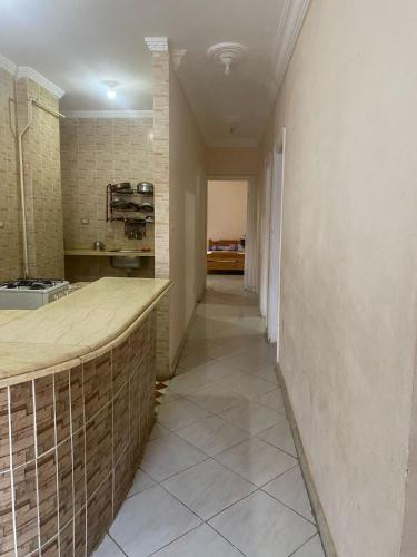 a hallway of a kitchen with a counter in a room at شقة 3 اوض في العوام in Marsa Matruh