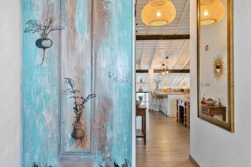 a room with a wall with a painting on it at Teal and Green - Alqueva Country House in Amieira