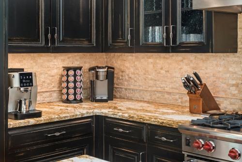 a kitchen with black cabinets and a counter top at Meadow Mountain Vista Multi-level 3br W Hot Tub in Snowmass Village