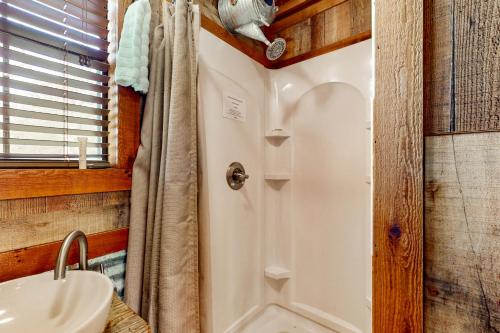 a bathroom with a shower and a sink at 4 Cabins - Reindeer Ranch at Round Top in Carmine