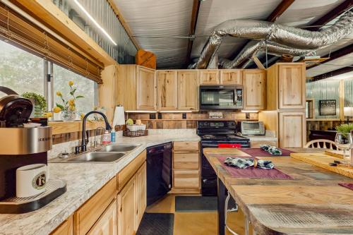 a large kitchen with wooden cabinets and a counter top at 4 Cabins - Reindeer Ranch at Round Top in Carmine