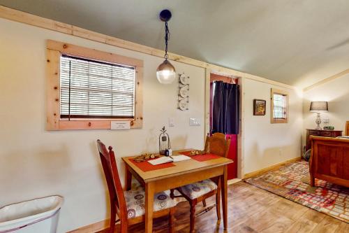 a dining room with a table and a window at 4 Cabins - Reindeer Ranch at Round Top in Carmine