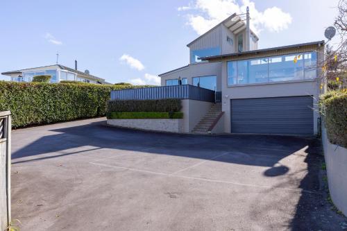 a large white house with a garage at Sanctuary 53 Beautiful Views in Taupo