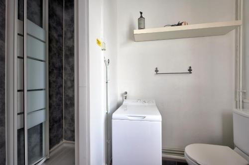 une salle de bain blanche avec des toilettes et un lavabo dans l'établissement T1 Confortable avec parking, proche Lyon, Idéal couples ou travailleurs, à Corbas