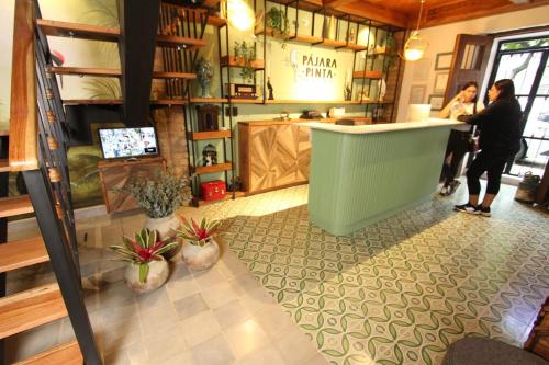 a woman standing at a counter in a store at Hotel Pajara Pinta in Cali