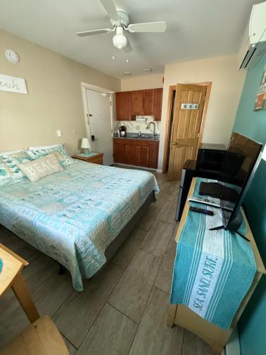 a bedroom with a bed and a desk in it at Pine View Lodge Old Orchard Beach in Old Orchard Beach