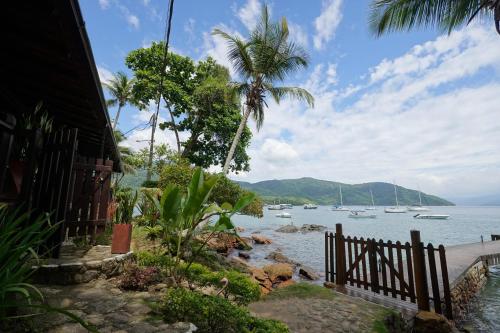 a view of a beach with boats in the water at Casa da Ilha & SPA in Abraão