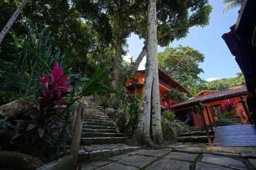 a set of stairs leading to a house with trees at Casa da Ilha & SPA in Abraão