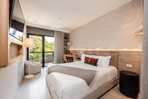 a bedroom with a large white bed in a room at Landmark Hotel in Medellín