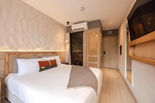 a bedroom with a large white bed in a room at Landmark Hotel in Medellín
