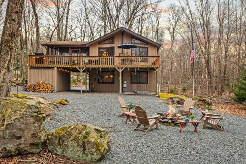a cabin in the woods with chairs and a table at Atlas Point Lodge Sauna Fireplaces Kayaks Lakes Pet-Friendly Yard in Pocono Lake