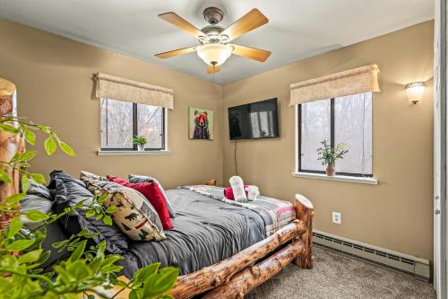 a bedroom with a bed and a ceiling fan at Atlas Point Lodge Sauna Fireplaces Kayaks Lakes Pet-Friendly Yard in Pocono Lake