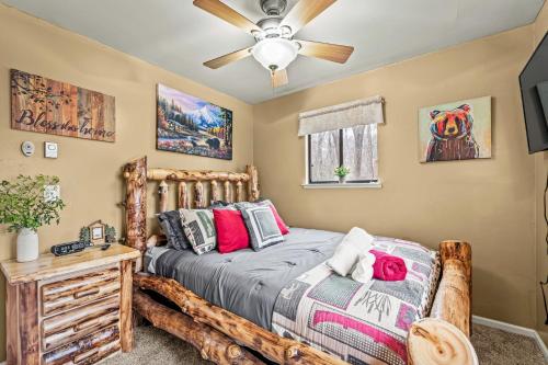 a bedroom with a bed and a ceiling fan at Atlas Point Lodge Sauna Fireplaces Kayaks Lakes Pet-Friendly Yard in Pocono Lake