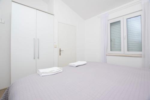 Postel nebo postele na pokoji v ubytování Apartments Pero