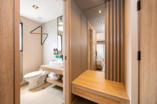 a bathroom with a toilet and a sink at Landmark Hotel in Medellín