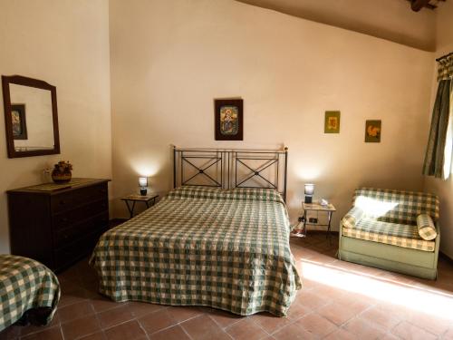 a bedroom with a bed and a dresser and a couch at Agriturismo Baglio Fontana in Buseto Palizzolo