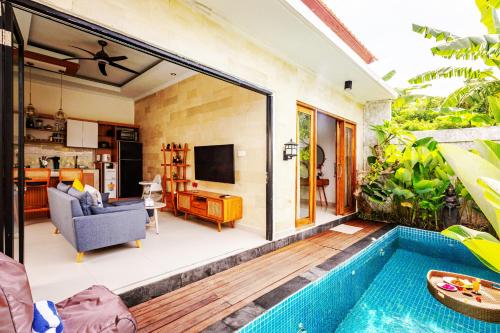 a house with a swimming pool and a living room at Villa Mewah di Nusa Penida in Nusa Penida