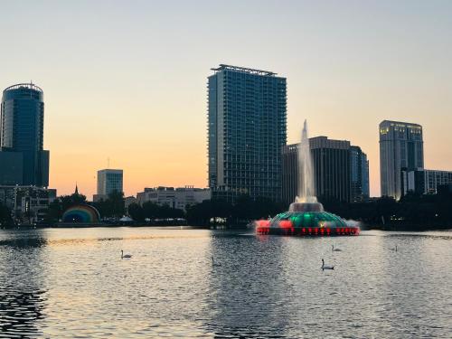 a fountain in the middle of a body of water with a city at Holiday Inn Orlando International Airport by IHG in Orlando