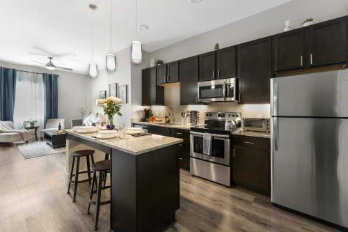 a kitchen with black cabinets and stainless steel appliances at 1 Mi to Dtwn Cozy Retreat in Golden, CO! in Golden