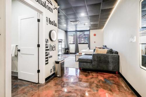 a living room with a couch and a door at New Loft 3 min to Childrens Hospital Sleeps 4 in Pittsburgh