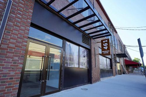 a brick building with glass doors on a street at New Loft 3 min to Childrens Hospital Sleeps 4 in Pittsburgh