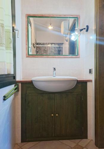 a bathroom with a sink and a mirror at Sa Domixedda in Villasimius