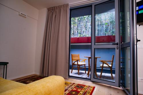 a living room with a table and chairs and a window at Varanini Luxury Suites double bedroom plus two and sauna in Milan