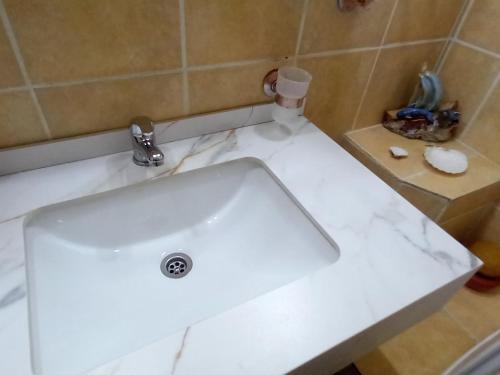 a white sink in a bathroom at Apartment Navigator's lodging in Kotor