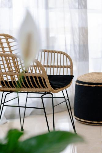 a room with two chairs and a flower on a table at La Hacienda cozy home in Pigi
