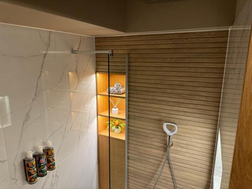 a bathroom with a shower with a glass door at Hot tub on the Yorkshire Wolds Oak Cottage in South Cave