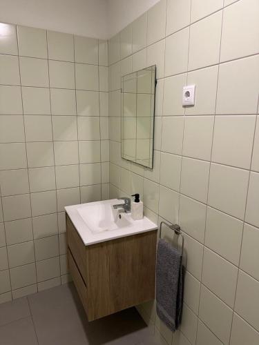 a bathroom with a sink and a mirror at Casa da Joana T2 no Centro Histórico de Angra in Angra do Heroísmo