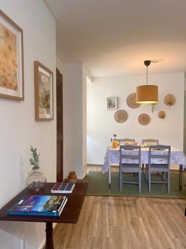 a living room with a table and a dining room at Casa da Joana T2 no Centro Histórico de Angra in Angra do Heroísmo