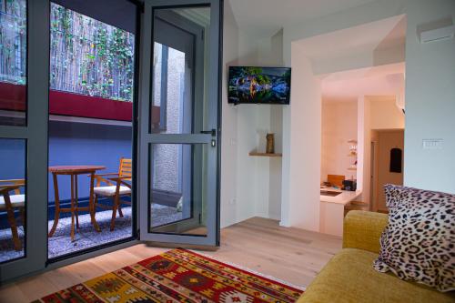a living room with a couch and a tv at Varanini Luxury Suites double bedroom plus two and sauna in Milan