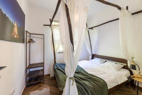 a bedroom with a bed with a canopy at Gora Apartments 3 in Vrdnik