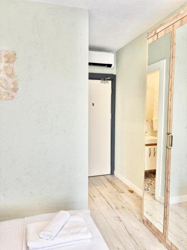 a room with a bed and a mirror at AKSOY TAŞ EV in Bodrum City