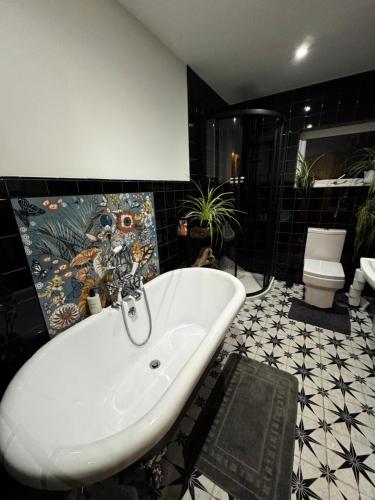a bathroom with a bath tub and a sink at Detached Home Close to the Beach Newquay in Saint Columb Minor