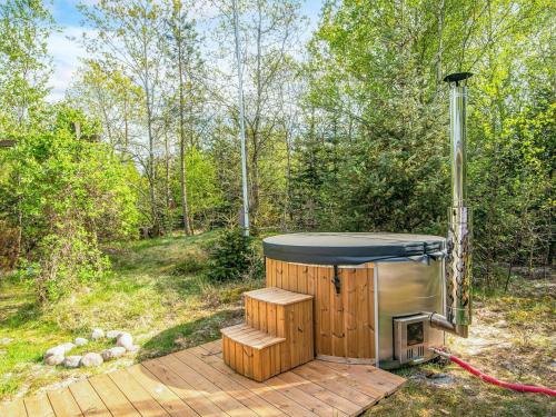 a sauna sitting on a wooden deck in the woods at 6 person holiday home in Brovst-By Traum in Brovst