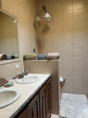 a bathroom with a sink and a mirror at Casa Cupulas in Puerto Peñasco