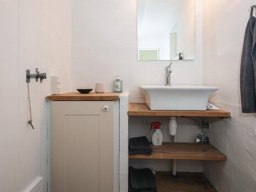 a bathroom with a sink and a mirror at 6 person holiday home in Grenaa in Grenå