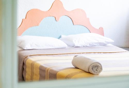 a bedroom with two beds with a wooden headboard at Hotel Flor de Maria in Puerto Escondido