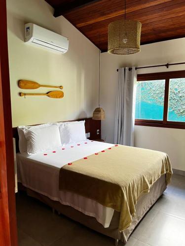a bedroom with a large bed in a room at Tropicália Chalés Boutique in Pipa