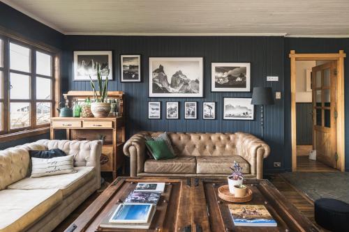 a living room with a couch and a table at Bories - Boutique Guest House in Puerto Natales
