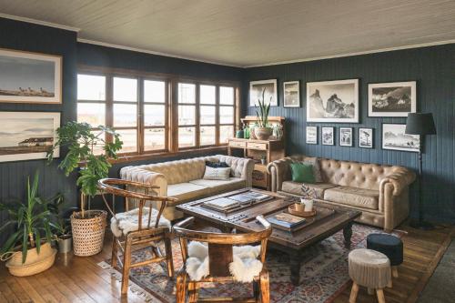 a living room with a couch and a table at Bories - Boutique Guest House in Puerto Natales