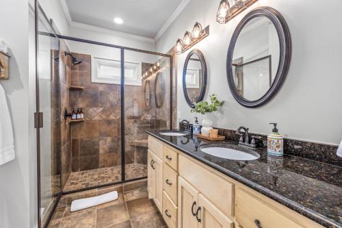 a bathroom with a shower and a sink at The Buford Manor in Buford