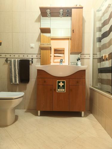 a bathroom with a sink and a toilet at Island Escape - Blue Residence in Conceição