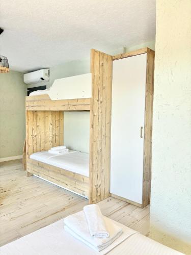 a room with a bunk bed with a door open at AKSOY TAŞ EV in Bodrum City