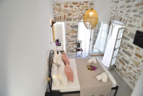 a room with a table with three ties on it at Axilleion Boutique Hotel in Ermoupoli