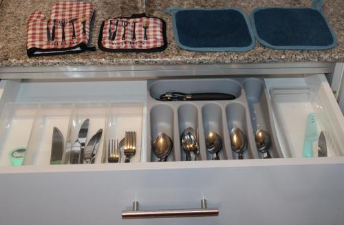 a drawer filled with utensils in a kitchen at Cozy & Convenient 1-Bedroom Condo 3 mins Away from the Airport in Lapu Lapu City