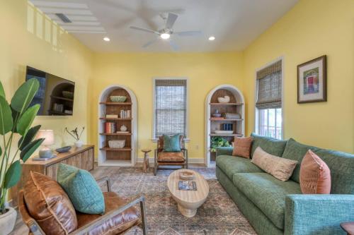 a living room with a green couch and a table at 61 Spanish St. Unit A in St. Augustine