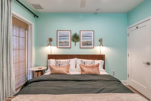 a bedroom with blue walls and a bed with pillows at 61 Spanish St. Unit B in St. Augustine